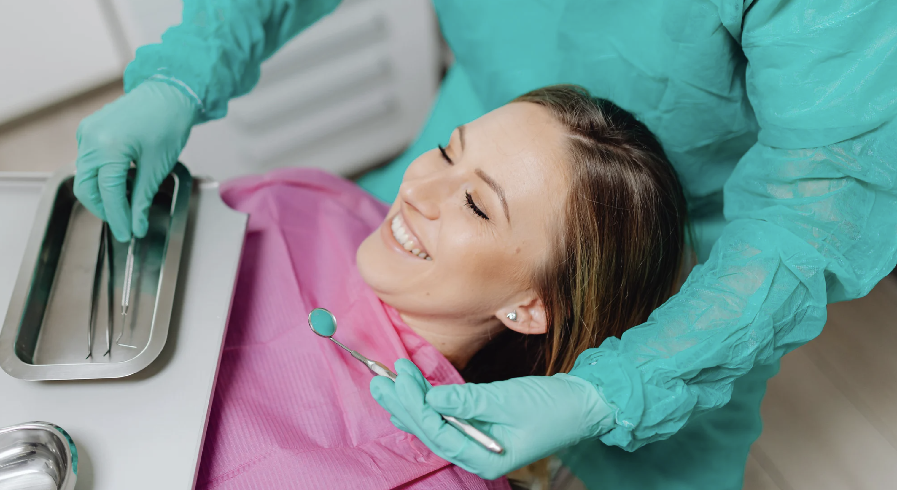 A smiling woman getting dental treatment