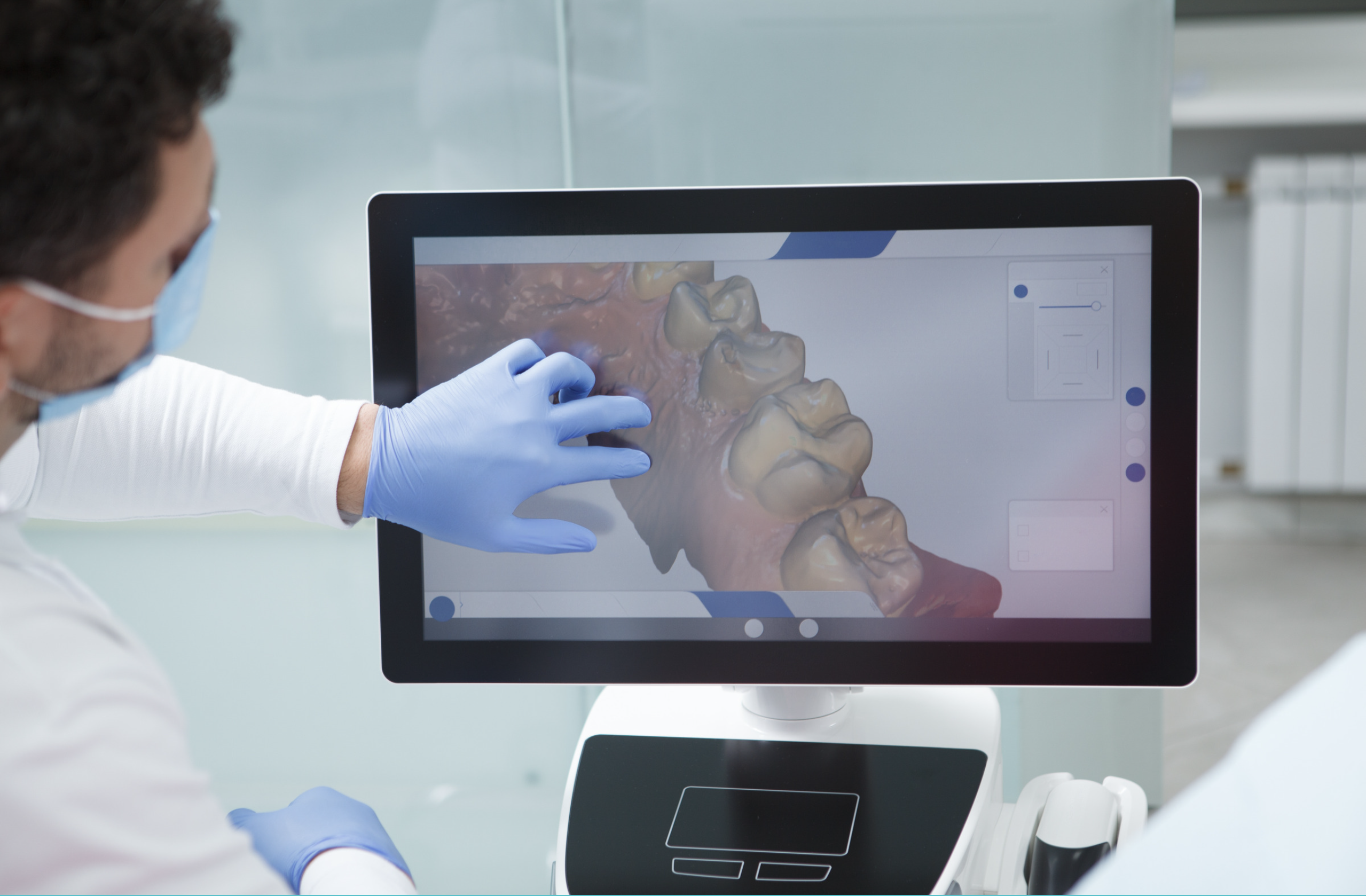 A dentist looking at a digital dental scan