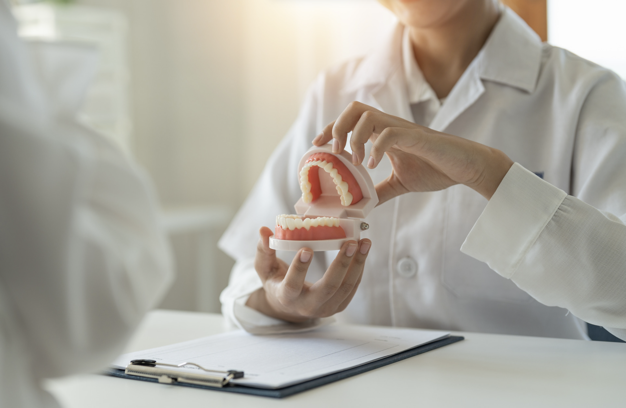 Dentists discussing a patient’s dental health and a treatment plan for bad breath.