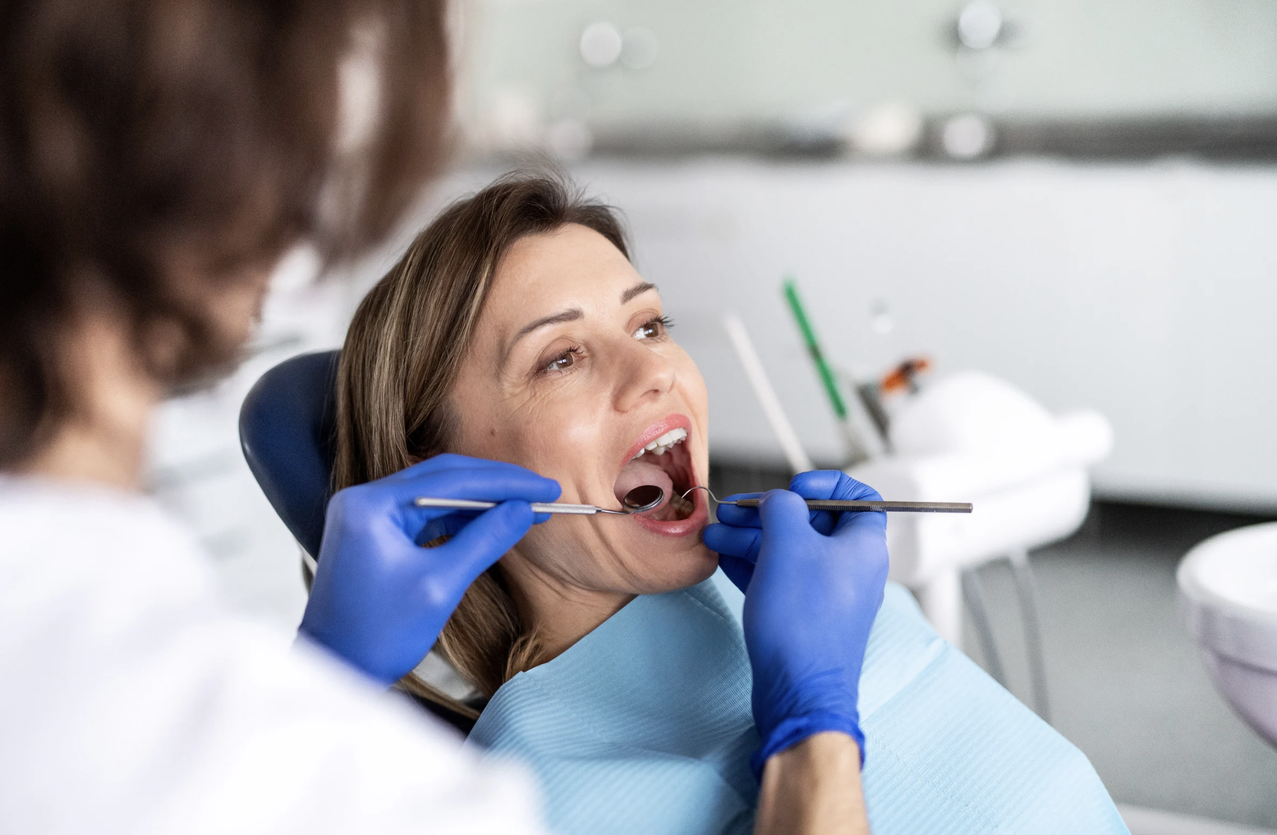 A dental check-up for a patient suffering pain from teeth sensitive to cold drinks
