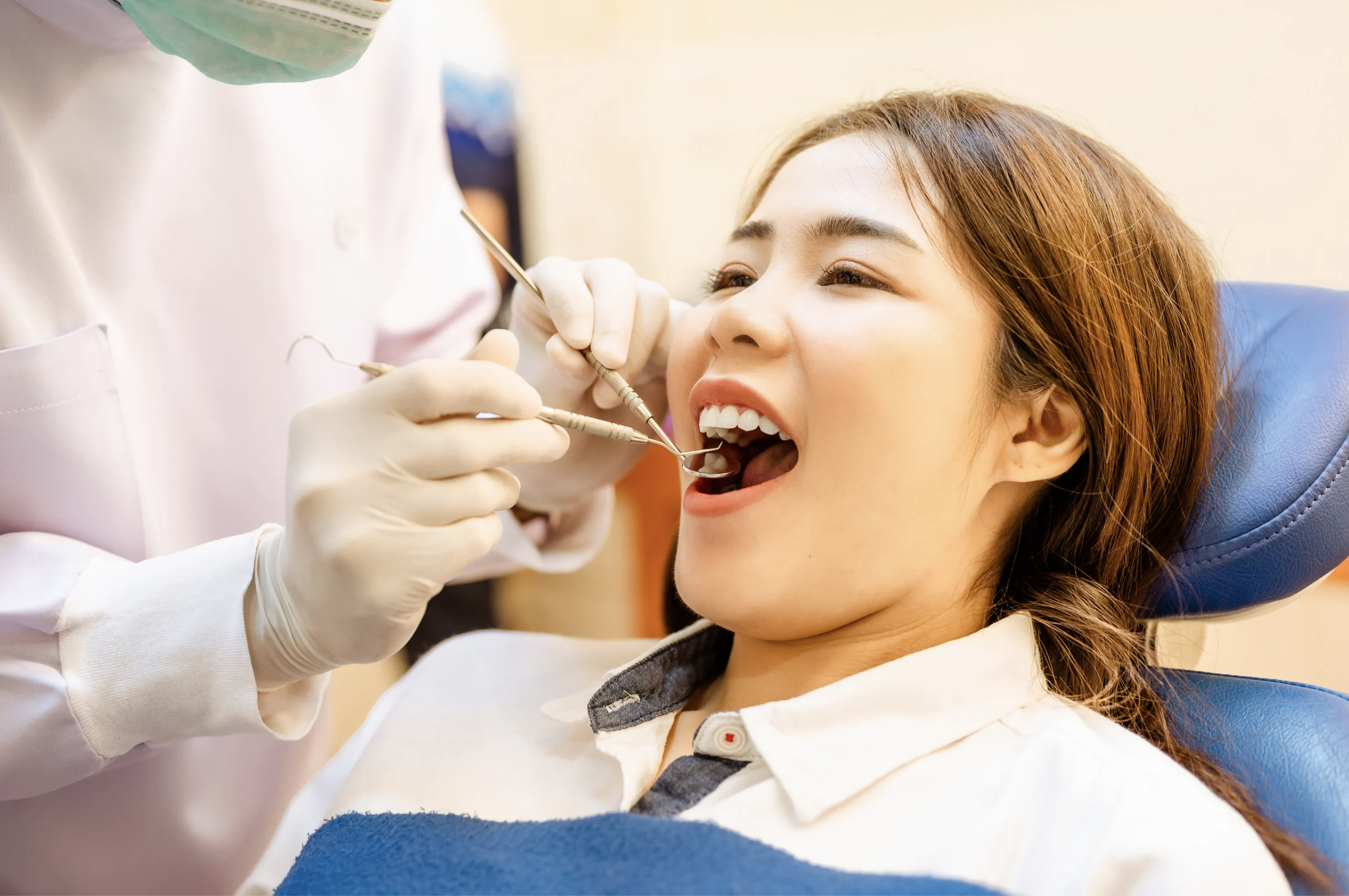 A dentist performs a routine dental scaling procedure for a patient.